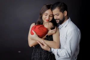 A man and woman holding a baby in their arms.